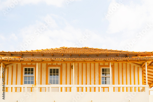 yellow striped house on the coast