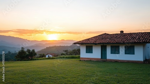 Serene countryside landscape with a traditional house against a vibrant sunset backdrop and rolling mountains in the distance