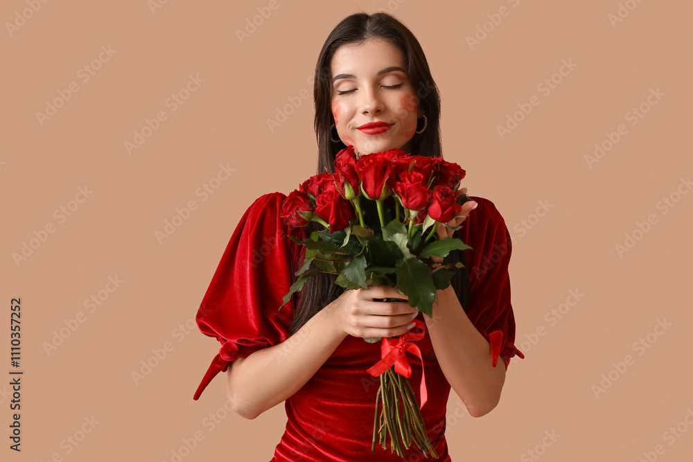 Beautiful young woman with kiss marks on her face and bouquet of roses on brown background Beautiful young woman with kiss marks on her face and bouquet of roses on brown background