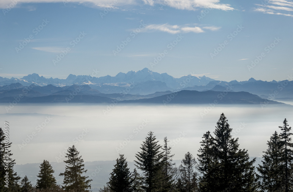 Scenic alpine landscape with fog and majestic mountains Scenic alpine landscape with fog and majestic mountains