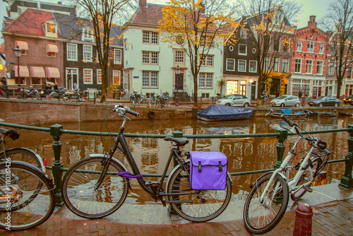 Canvas Print Evening autumn streets and canals of Amsterdam. Bicycles.