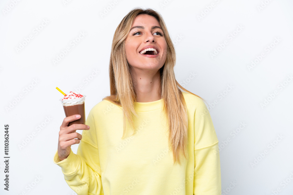 Young Uruguayan woman holding Frappuccino isolated on white background laughing Young Uruguayan woman holding Frappuccino isolated on white background laughing