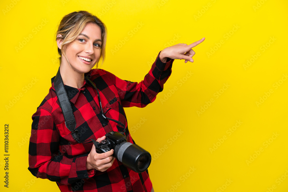 Uruguayan photographer woman isolated on yellow background pointing finger to the side and presenting a product Uruguayan photographer woman isolated on yellow background pointing finger to the side and presenting a product