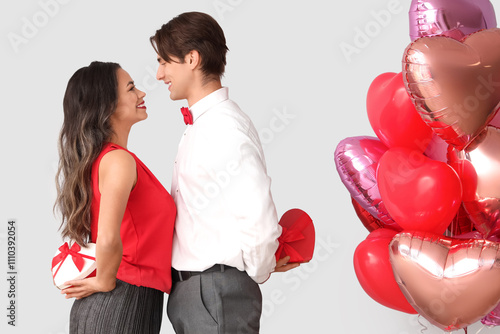 Young couple with gifts and...