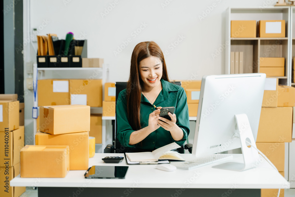 Business owner woman prepare parcel box and standing check online orders for deliver Business owner woman prepare parcel box and standing check online orders for deliver