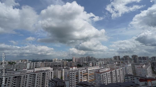 Time lapse video of urban building with white clouds above Singapore HDB estate