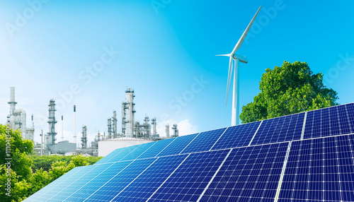 Solar panel and wind turbine - Renewable energy for Green industry. Oil refinery plant, large Oil and gas petrochemical industrial, oil storage tank and pipeline, Ecosystem and good environment.