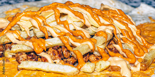 A close-up of a fresh wrap being filled with crispy fries and tangy sauce.