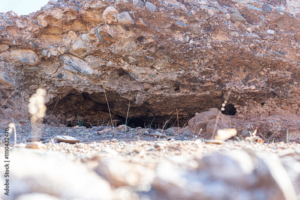 Geological textures and earthy tones of natural rock layers in southern Morocco, near Marrakech.