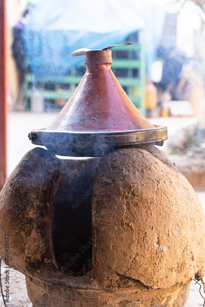 A traditional tagine cooking over fire, showcasing the rich culinary heritage of the Maghreb region.