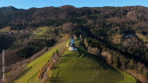 Saint Primoz and Felician, Jamnik, Slovenija / Slovenia, A hill top church in the mid day, late autumn, photogenic church, drone shot, aerial footage, amazing clip. photo