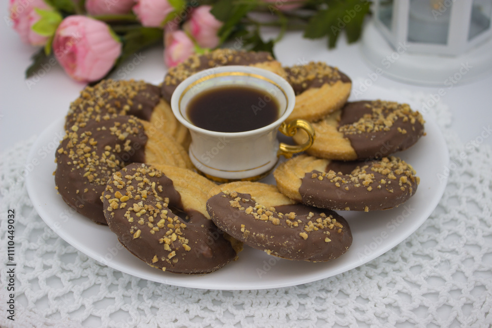 Round Chocolate Cookies with Coffee on White Plate Round Chocolate Cookies with Coffee on White Plate