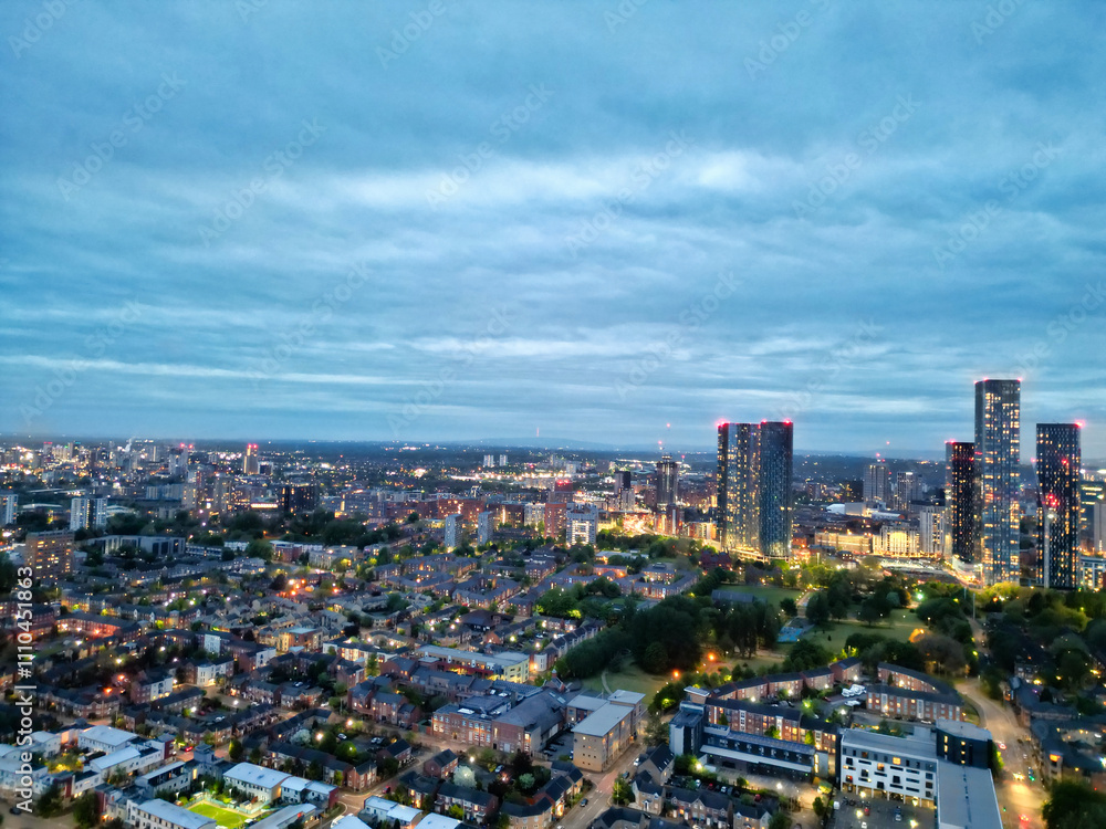 Fototapeta premium High Angle View of iconic Buildings at Central Greater Manchester City Centre and Tall Buildings During Golden Hour of Sunset over England UK. May 4th, 2024.