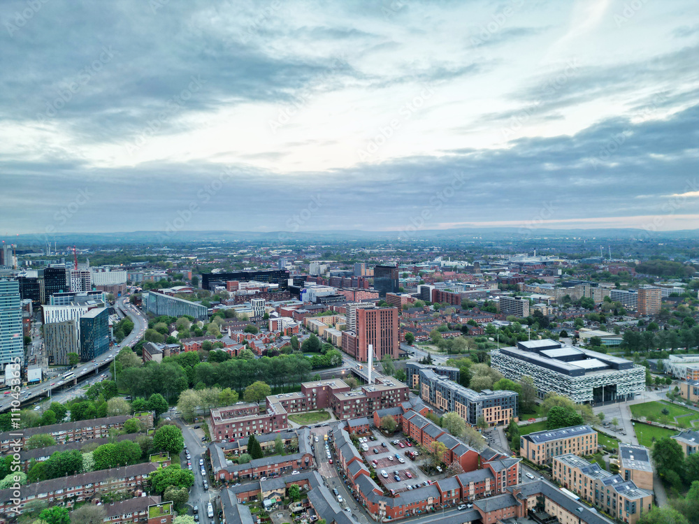 Fototapeta premium High Angle View of iconic Buildings at Central Greater Manchester City Centre and Tall Buildings During Golden Hour of Sunset over England UK. May 4th, 2024.