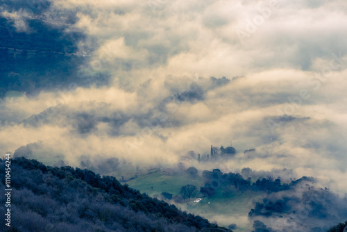 House in a foggy mountain landscape