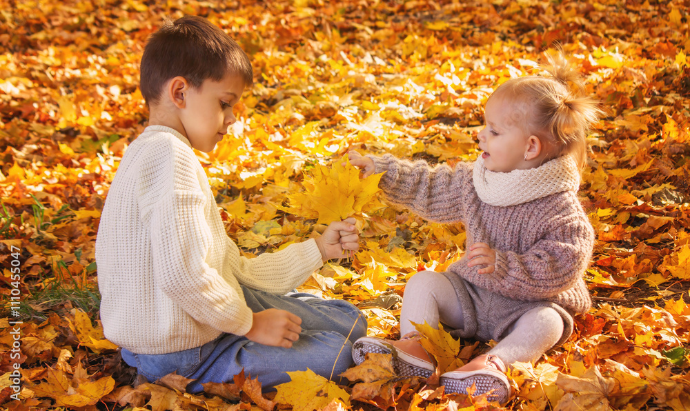 Happy children, boy and little girl in autumn park. Autumn Happy children, boy and little girl in autumn park. Autumn