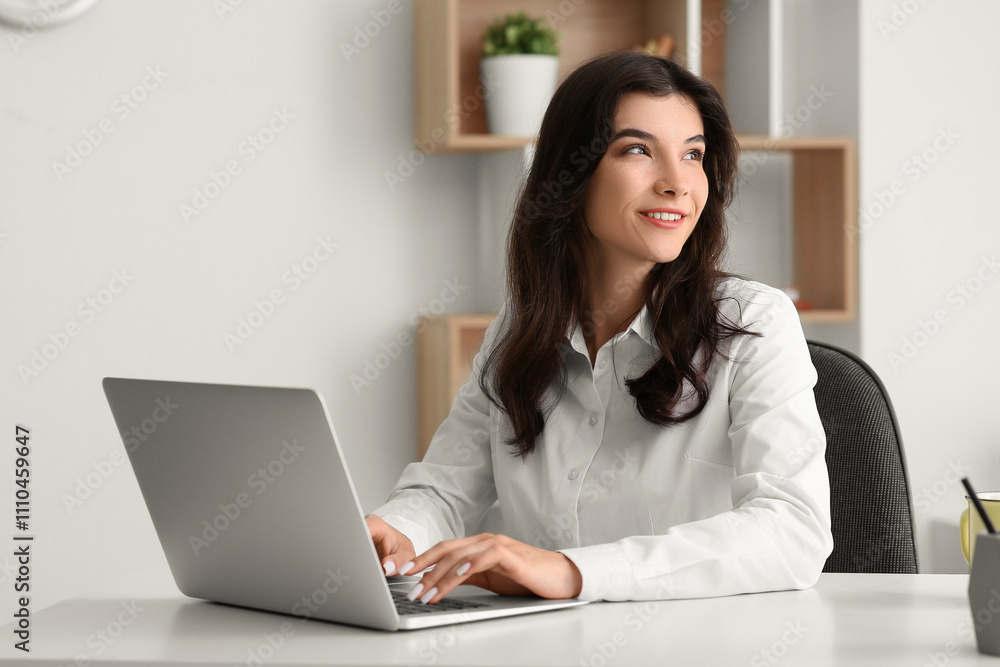 Beautiful young happy businesswoman working with laptop at office Beautiful young happy businesswoman working with laptop at office