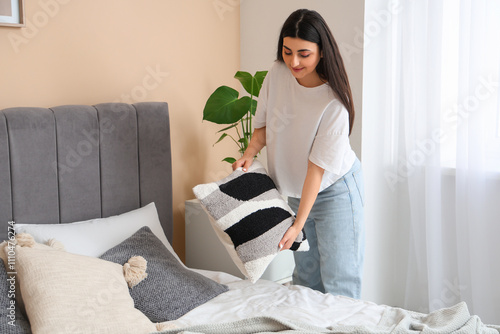 Young woman arranging decor...