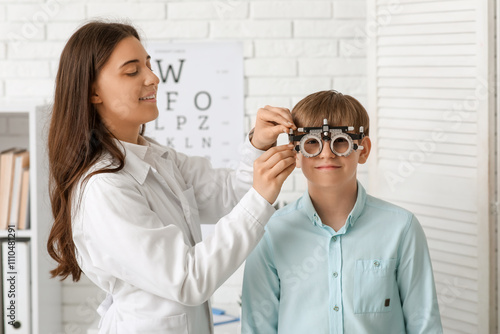 Female optometrist adjustin...