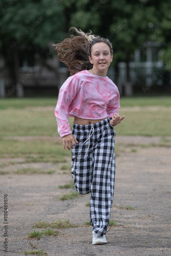 A young beautiful girl frolics in a summer park. A young beautiful girl frolics in a summer park.