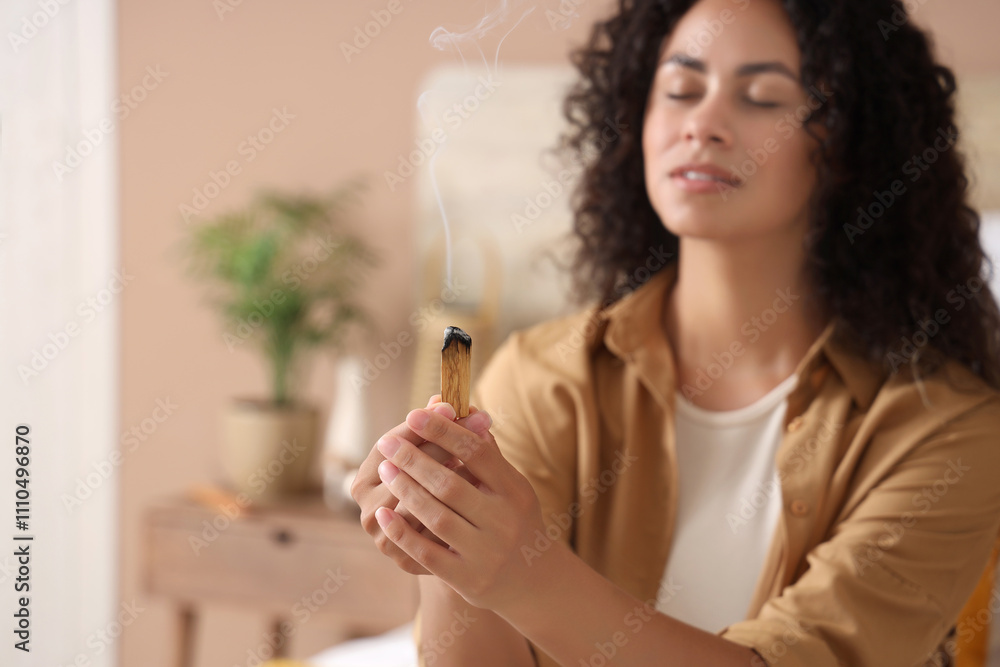 Young African-American woman with Palo Santo in bedroom, closeup Young African-American woman with Palo Santo in bedroom, closeup