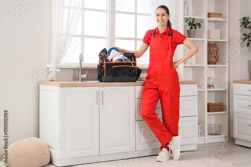 Smiling female plumber in r...