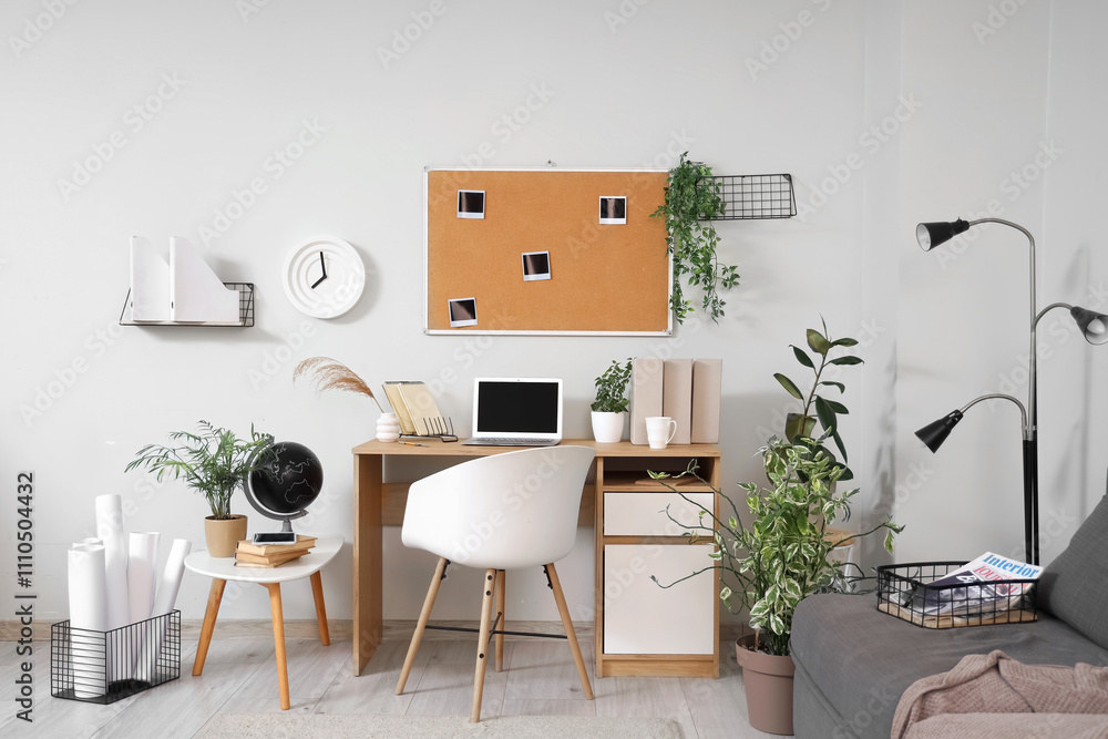 Interior of office with workplace, plants and pin board Interior of office with workplace, plants and pin board