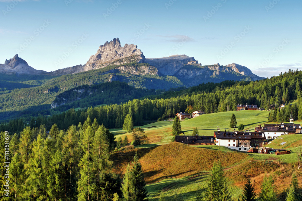 Fototapeta premium Mountain hut under steep mountains in the Italian Alps Dolomites, beautiful landscape