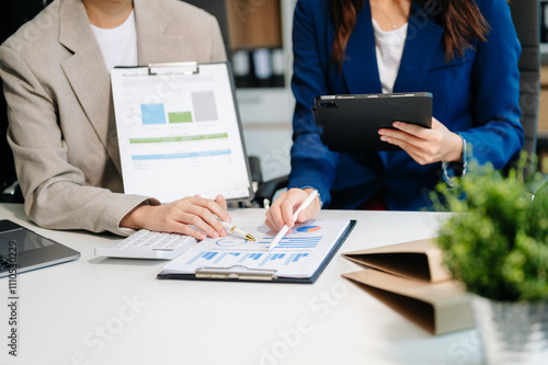 Businessman and team analyzing financial statement Finance task. with smart phone and laptop and tablet.