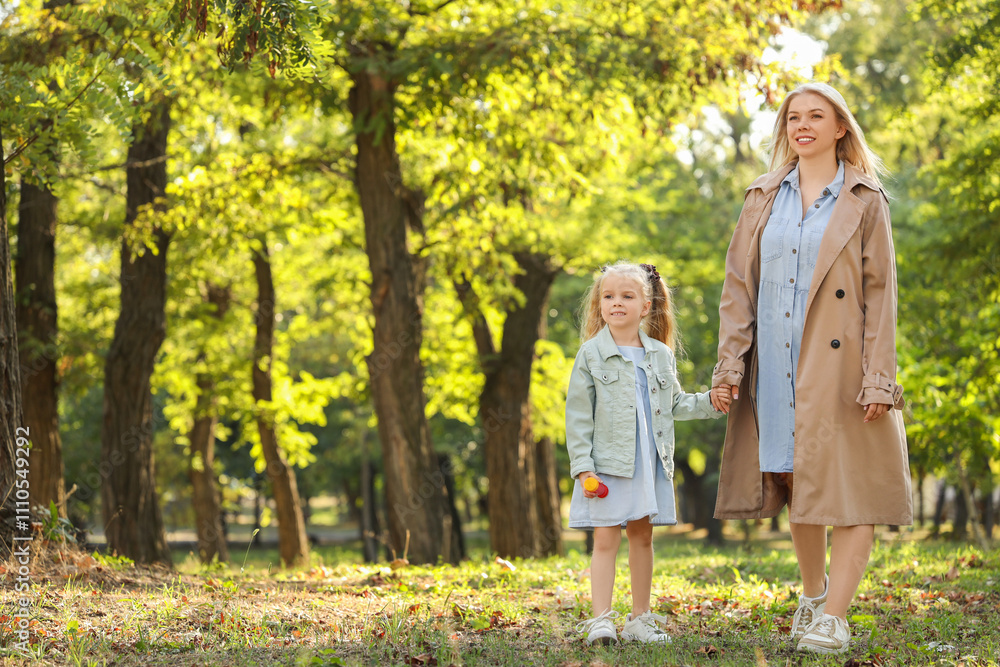 Fototapeta premium Happy mother with her little daughter walking in park on autumn day