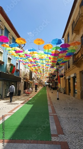 Parte do Caminho de Santiago de Compostela Português, seguindo pelo estreito decorado com sombrinhas coloridas. photo