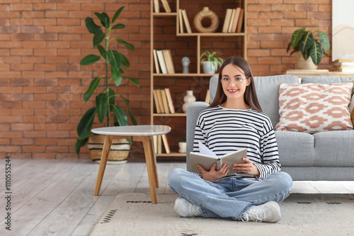 Smiling young woman reading...