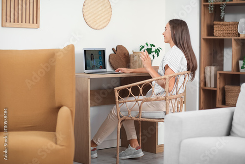 Young woman video chatting ...