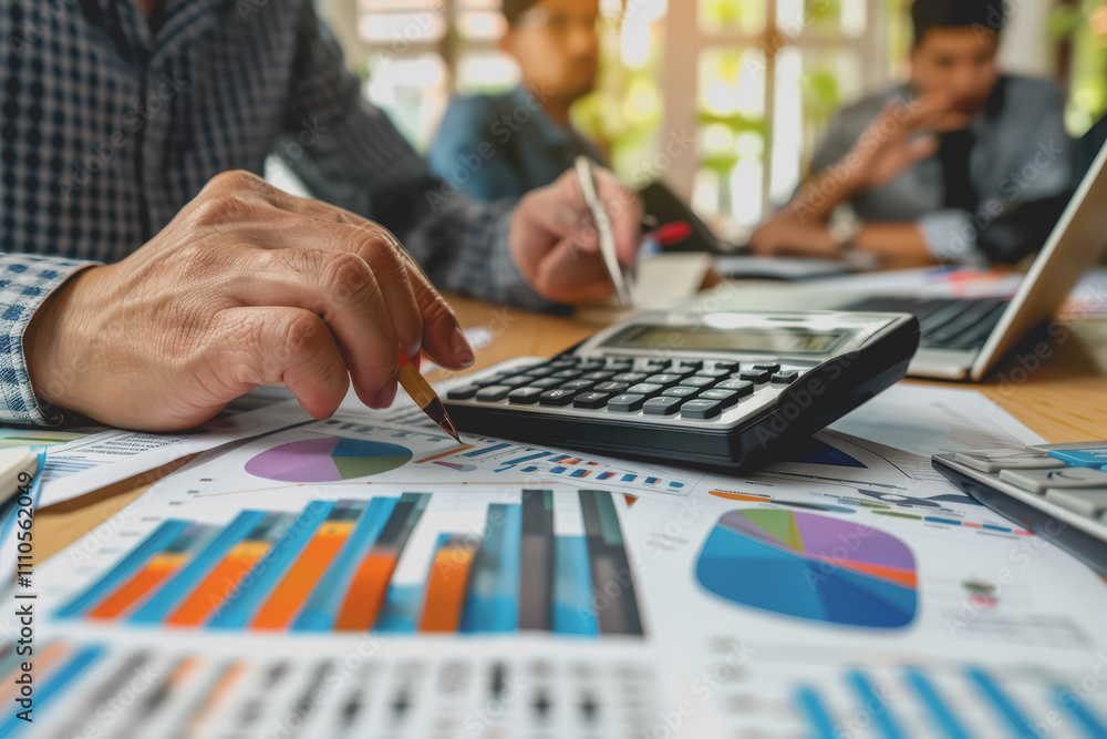 Business team meeting using chart calculator and analyzing business strategy financial statistics. Business team meeting using chart calculator and analyzing business strategy financial statistics.