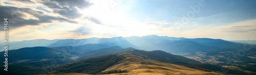 Panoramic view of Carpathian Mountains with sun rays, rolling hills, and majestic peaks under a blue sky.