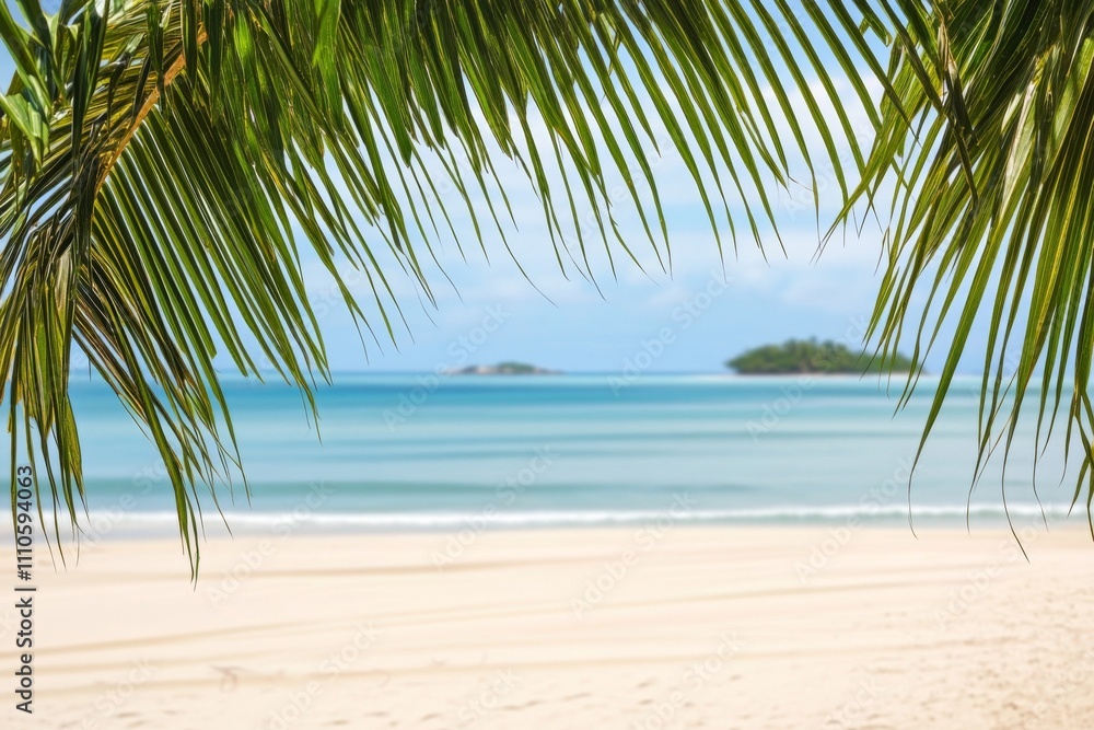 Fototapeta premium Tropical beach background with palm leaves, sandy shore, and blurred island in the distance.
