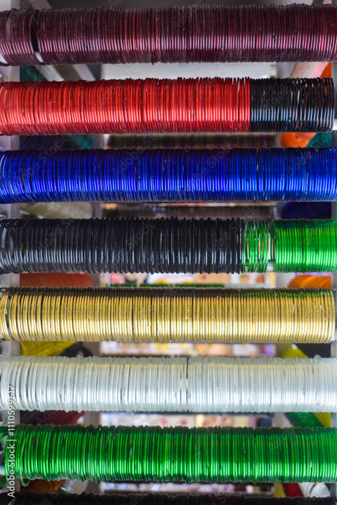 Rows of traditional colorful glass bangles and bracelets are displayed for selling in a handicraft fair shop at Kolkata. india and pakistan, multi color Beautiful Bangles, Hands wearing Jewelery Rows of traditional colorful glass bangles and bracelets are displayed for selling in a handicraft fair shop at Kolkata. india and pakistan, multi color Beautiful Bangles, Hands wearing Jewelery