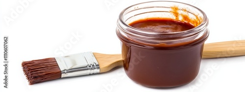 A tangy barbecue sauce in a glass jar with a brush, isolated white background, realism art style photo