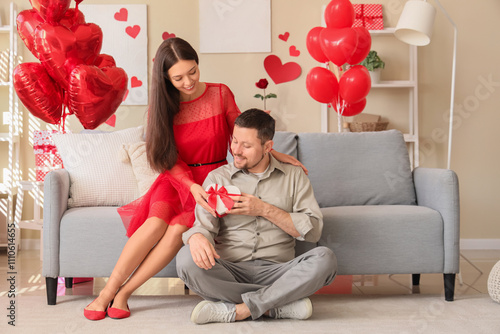 Young couple with gift box ...