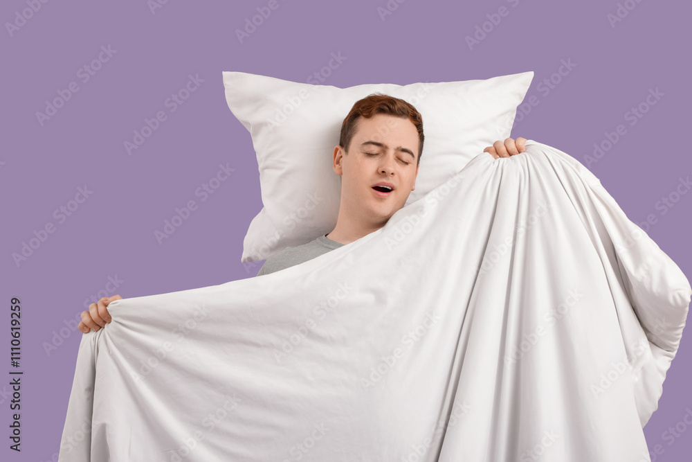 Young man with pillow and blanket sleeping on lilac background Young man with pillow and blanket sleeping on lilac background