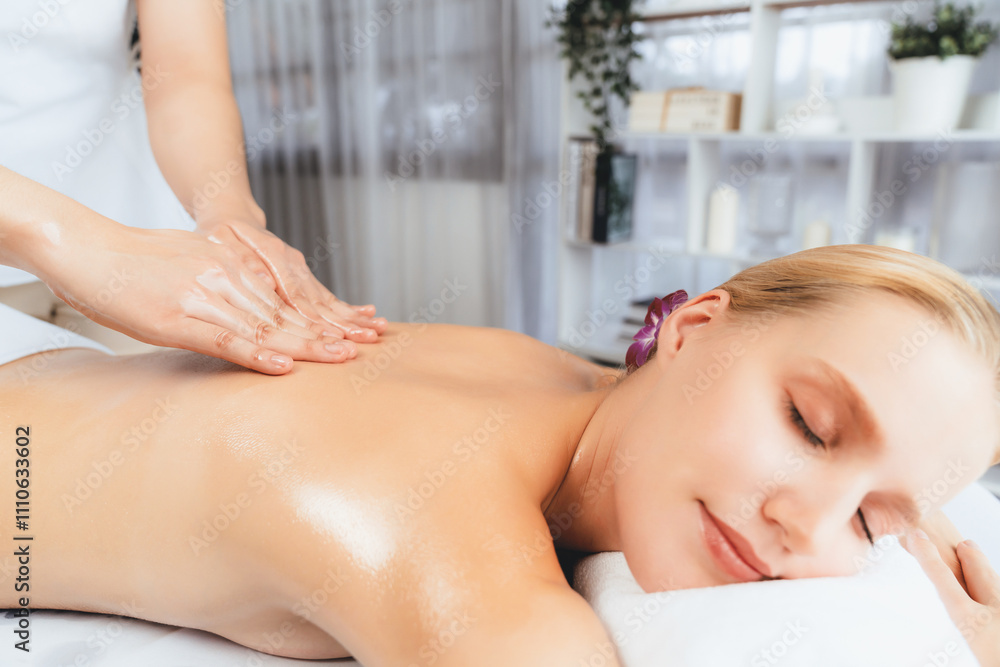 Closeup woman customer enjoying relaxing anti-stress spa massage and pampering with beauty skin recreation leisure in day light ambient salon spa at luxury resort or hotel. Quiescent Closeup woman customer enjoying relaxing anti-stress spa massage and pampering with beauty skin recreation leisure in day light ambient salon spa at luxury resort or hotel. Quiescent
