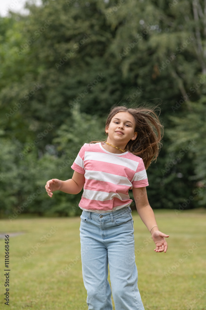 A young beautiful girl frolics in a summer park. A young beautiful girl frolics in a summer park.