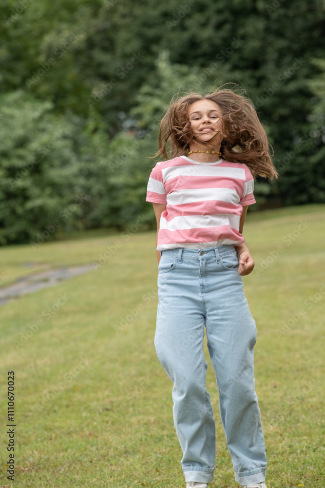 A young beautiful girl frolics in a summer park. A young beautiful girl frolics in a summer park.