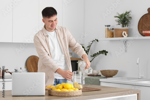 Young man pouring water int...