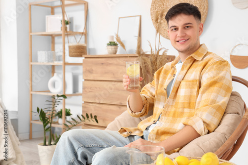Young man with glass of lem...