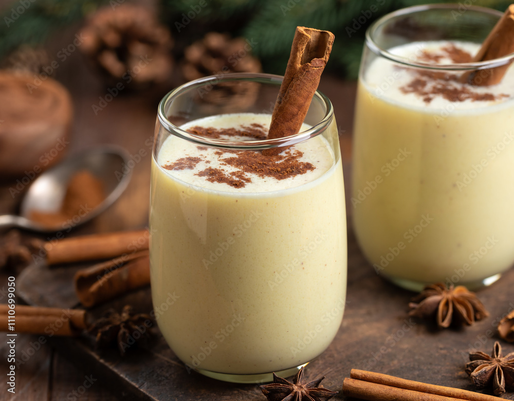 Two glasses of eggnog with cinnamon and anise Two glasses of eggnog with cinnamon and anise