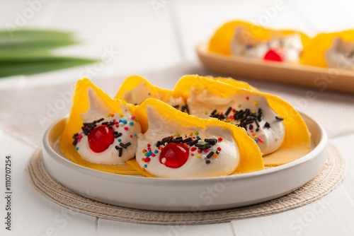 Thai crepes ,Thai Crispy Pancake topped with sweet cream fillings jelly and rainbow sprinkles topping(Kanom Buang).popular thai street food. photo