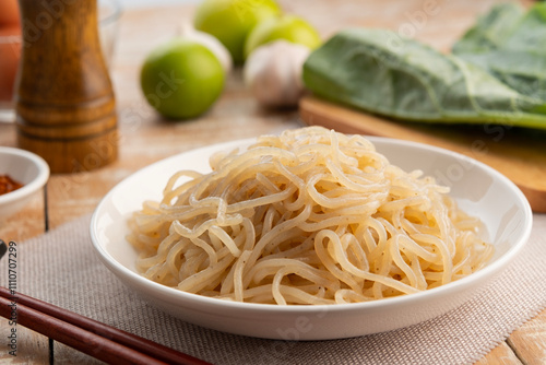 konjac noodles with seaweed in white plate,noodles made from the corm of the konjac yam,low calorie food for weight loss,ketogenic diet photo