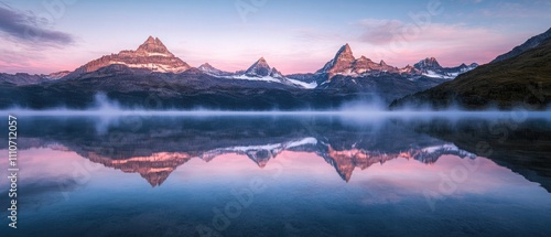 Serene reflections on a high-altitude lake at dawn, with mountain peaks mirrored perfectly in the glassy surface as faint mist begins to rise, creating a tranquil scene. photo