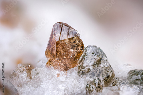 Brown titanite (left) with quartz (on the right) included with Quartz. Specimen from St gotthard massif, switzerland. Micro photography extreme close-up. photo